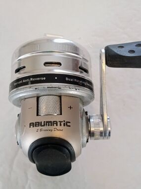 Silver Fishing Reel with Black Handle Grip